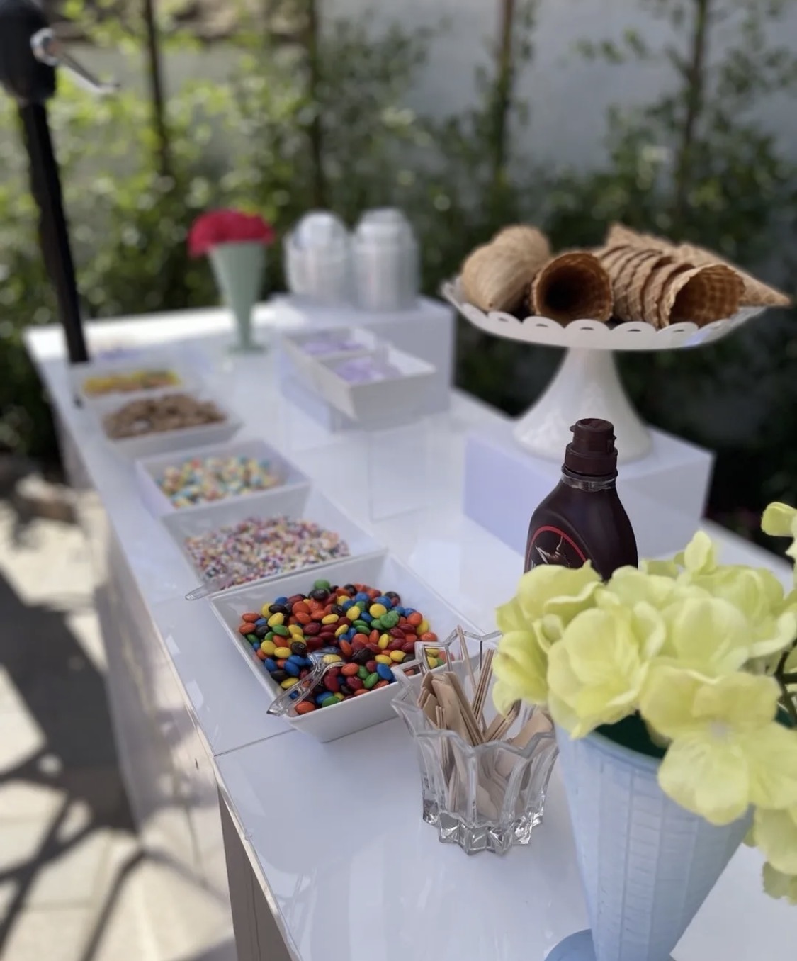Ice cream bar with cones, sauces and toppings