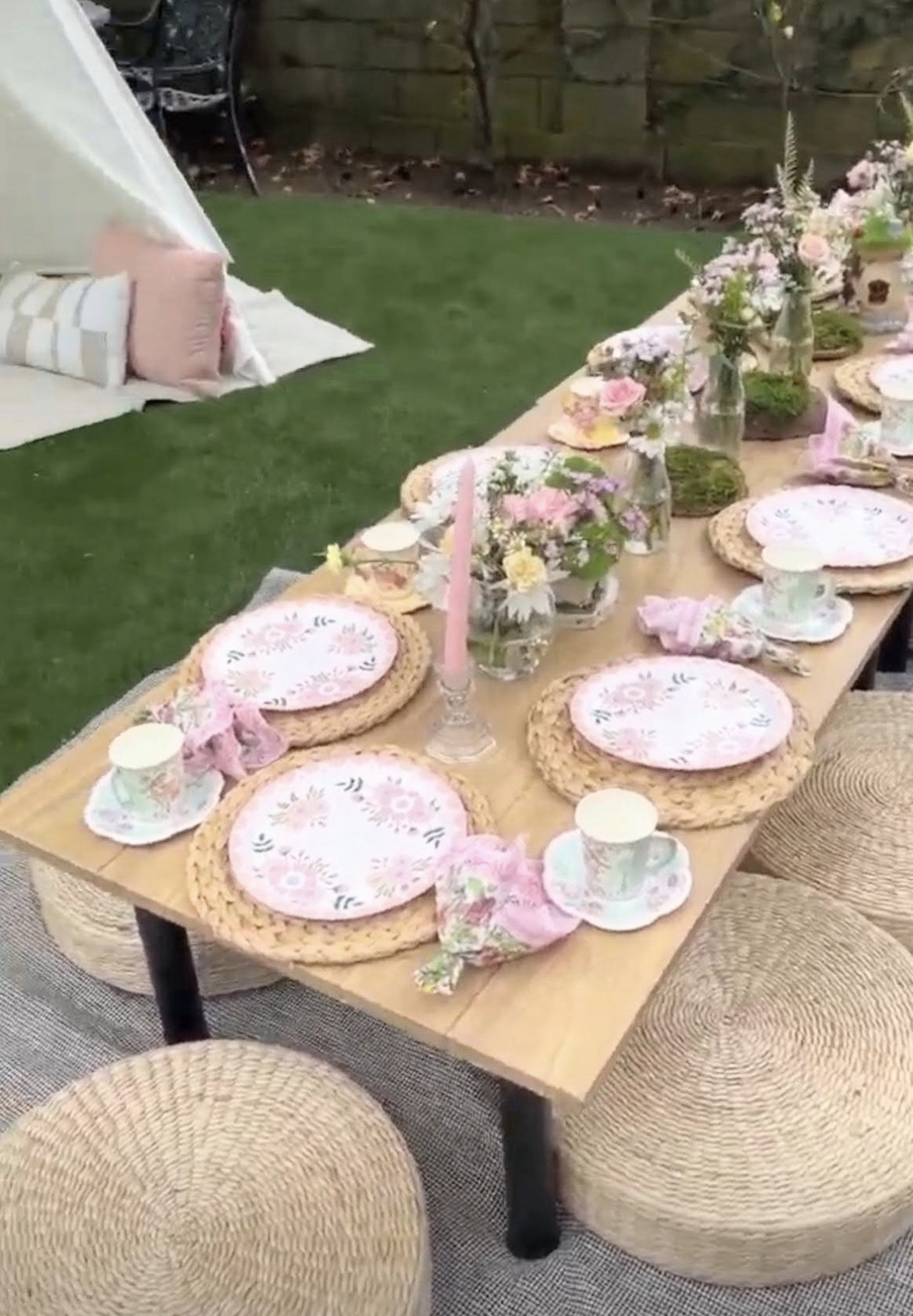 Blush garden picnic with low tables and cushions